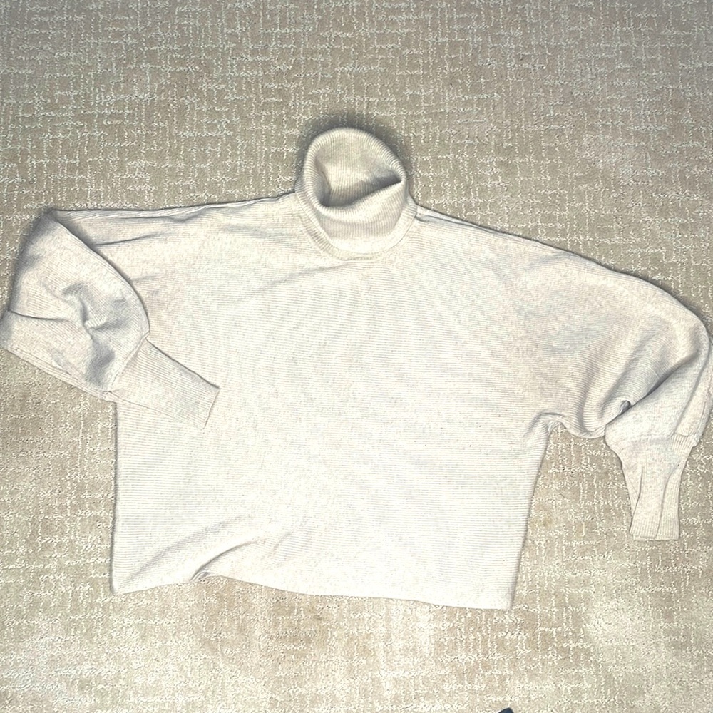 “Pink Rose” beige turtle-neck sweater.